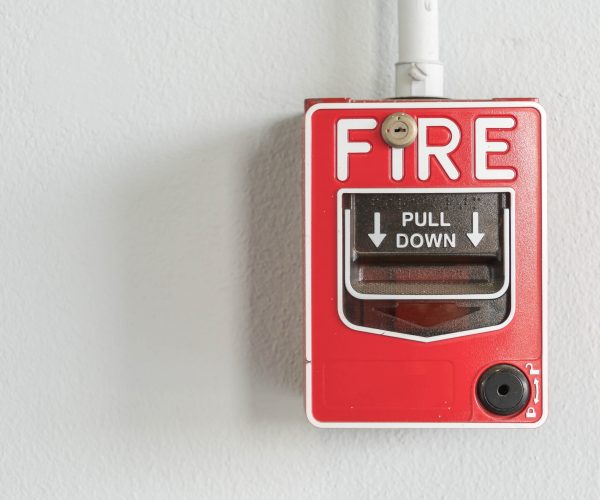 Fire alarm switch on white wall